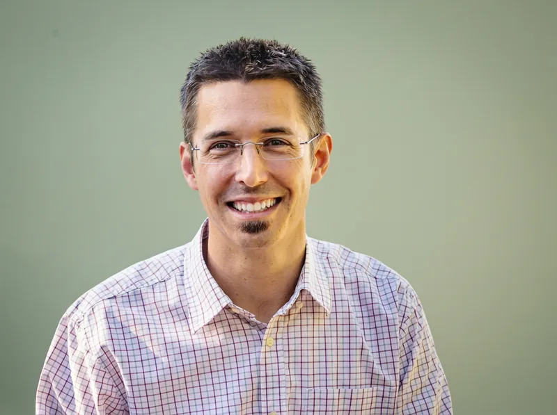Dr. Jake Pray, O.D., smiling in his office attire